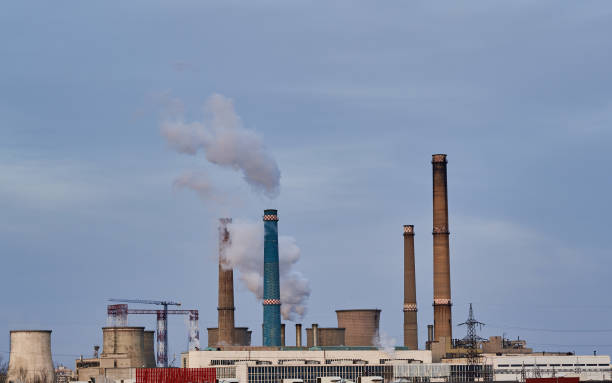 istock Industrial pollution with funnels and smoke 1384888071