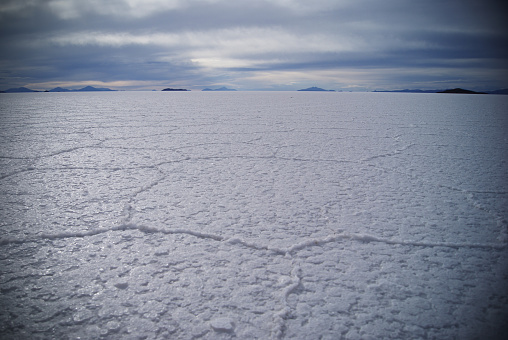 A ground level shot of expansive salt desert stretching towards the horizon in Uyuni, Bolivia.