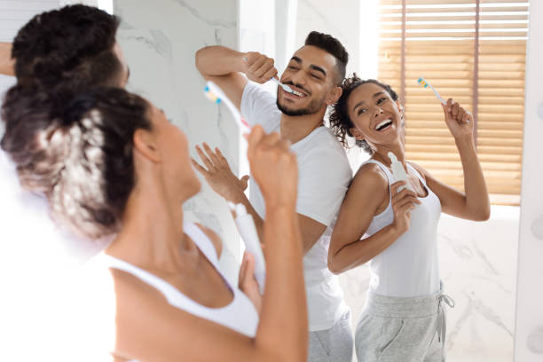 istock Morning Joy. Cheerful Millennial Arab Couple Dancing In Bathroom While Brushing Teeth 1384890834