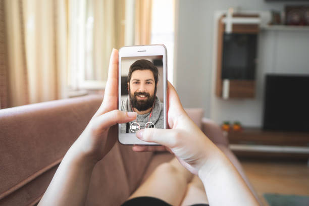 Young woman using smartphone for video call