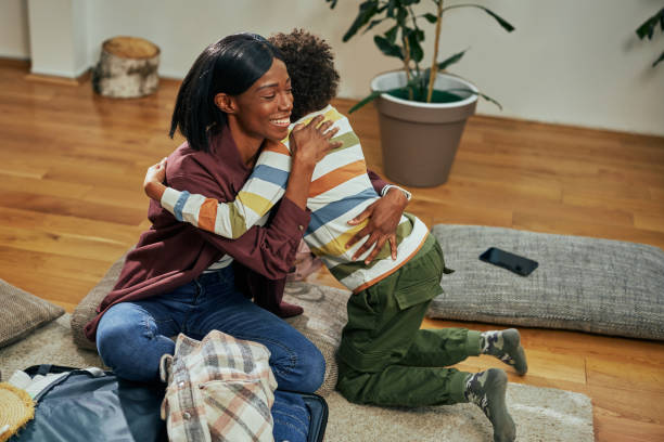 istock Mother and boy hugging at home 1384891904