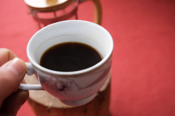 istock A pot of coffee holding by hand 1384891946