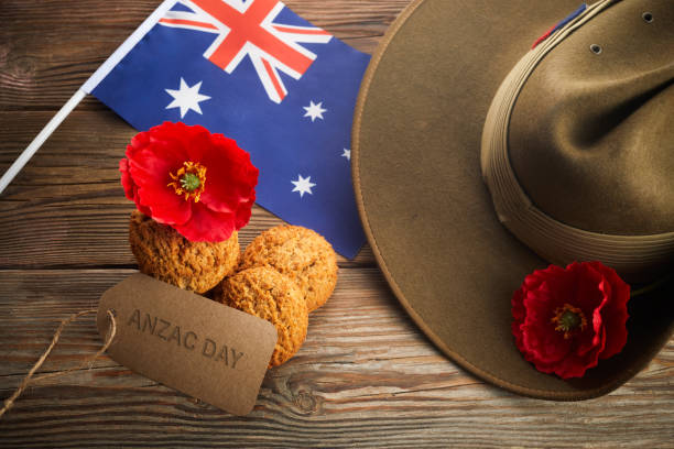 anzac day australiano. cappello da slouch dell'esercito australiano e biscotti tradizionali anzac su sfondo di legno. - slouch hat foto e immagini stock