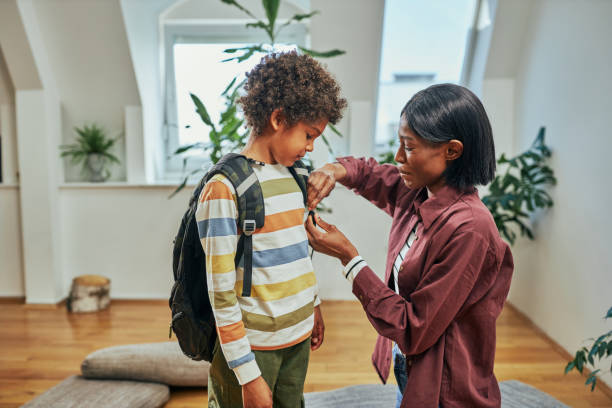 istock Single Mother helping her son get ready for school 1384893153