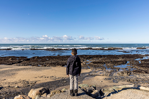 High quality stock photos of a 11-year-old boy exploring tidal pools on the Pacific Ocean.