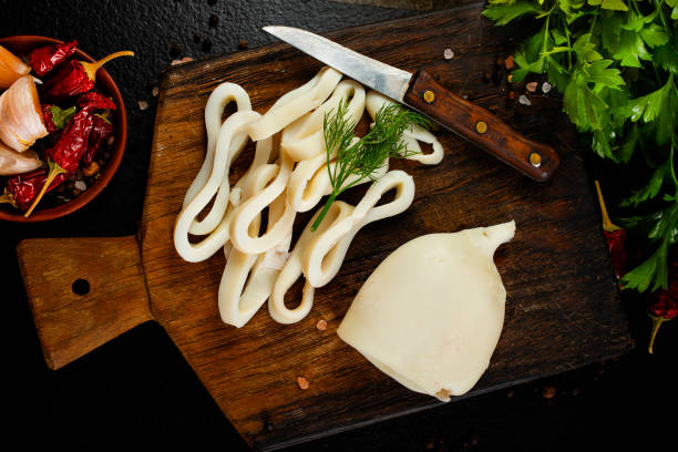 Slicing of boiled calamar on a cook-table stock photo