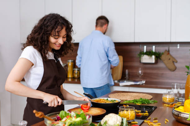 istock Couple cooking together. 1384895581
