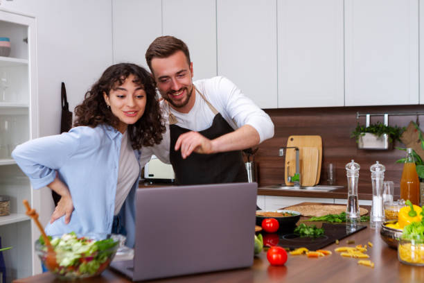 istock Couple cooking together. 1384895599