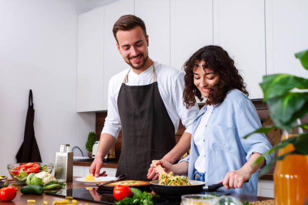 istock Couple cooking together. 1384895953