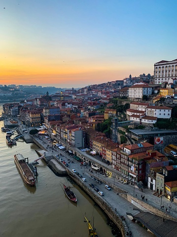 Ribeira charming area view from bridge. Douro river. Old medieval town in northern Portugal. Down town. Sunset twilight in city. Rooftop view.