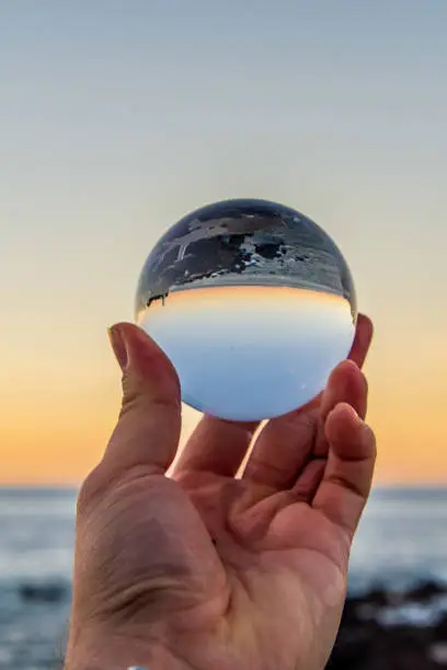 Sea and sky during a sunset reflected in a crystal ball