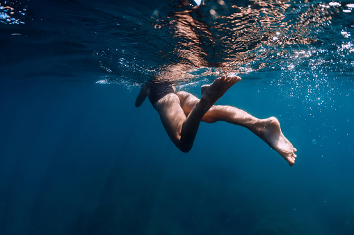 Sporty woman in bikini swimming in blue sea. Activity summer days in ocean