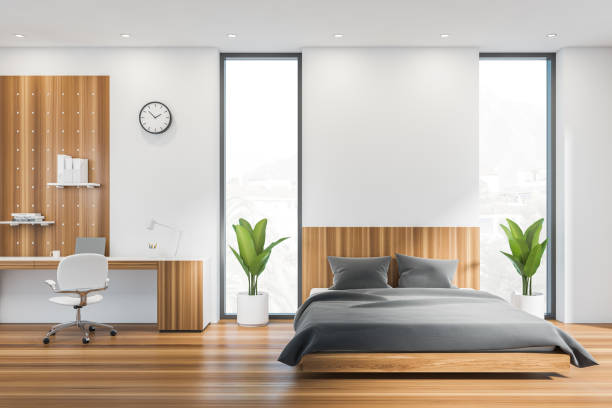 istock White empty wall, modern bedroom interior and home office with panoramic window, comfortable bed. Laptop on desk. Concept of modern life. Mockup copy space. 3d rendering. 1384898393