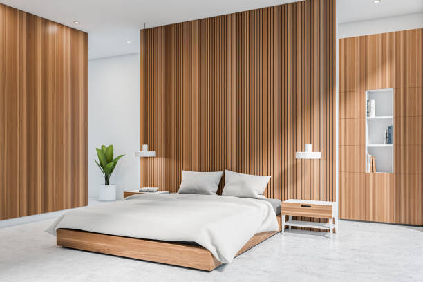 istock Corner view on bright bedroom interior with bed, white walls 1384898449