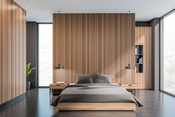 istock Dark bedroom interior with bed, panoramic window with town view 1384898564