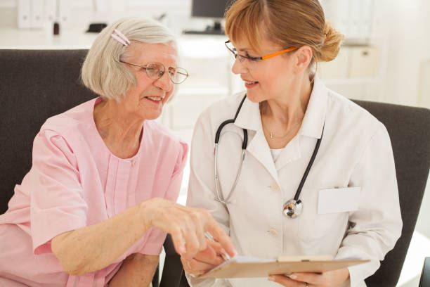 istock Senior woman visiting doctor. 1384898873