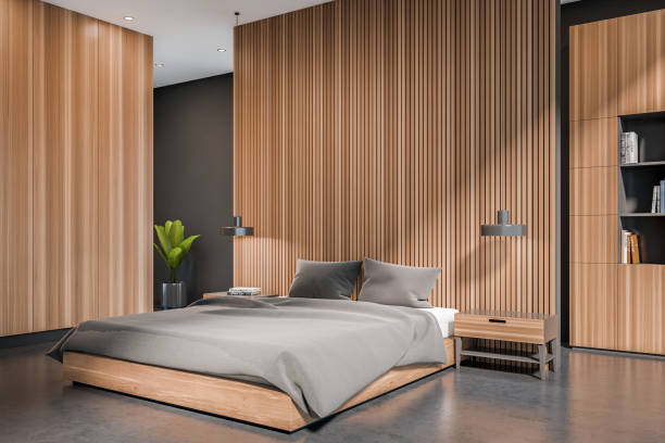 istock Corner view on dark bedroom interior with bed, grey walls 1384900208
