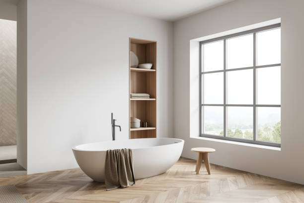 istock Bright bathroom interior with bathtub, panoramic window with countryside view 1384900263