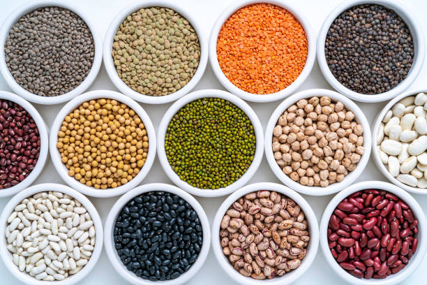 istock Dried legumes assorted in many bowls on white as lentils, chickpeas, soybeans and beans 1384900537