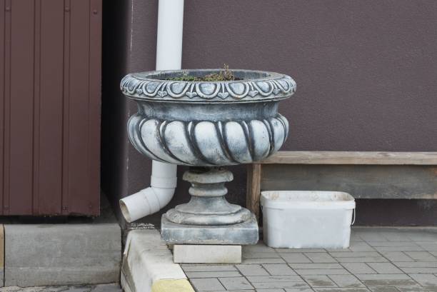 istock one gray large concrete flowerpot stands on the sidewalk 1384901428