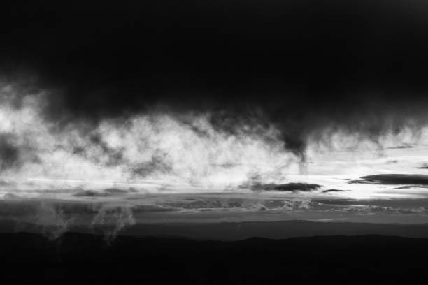 Moody cloudscape, with some very low clouds in the foreground.