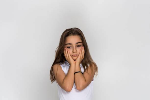 istock Little girl with hands on cheeks looking thoughtful 1384905927