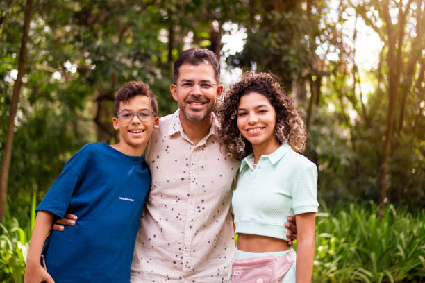 istock Father and sons in a public park 1384920278