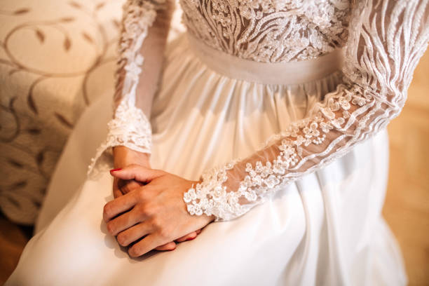 istock Bride in wedding dress holding her hand 1384921446