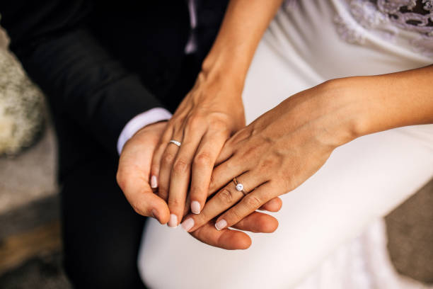 istock Newlywed couple holding their hands 1384921670