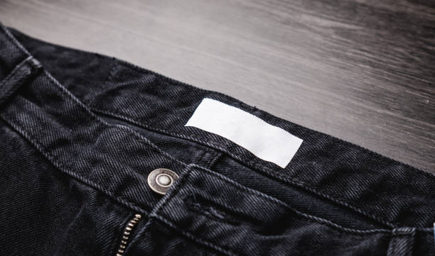 istock Blank clothing label on denim jeans texture. Label with empty space for text 1384922648