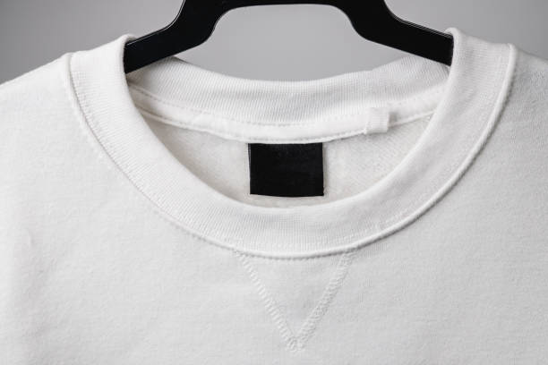 istock Empty black label on white sweatshirt for logo, size and info. 1384922656