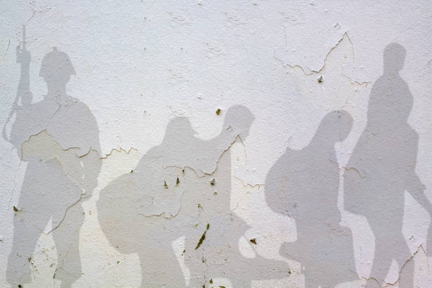 Soldier and Refugee shadows on wall . War concept