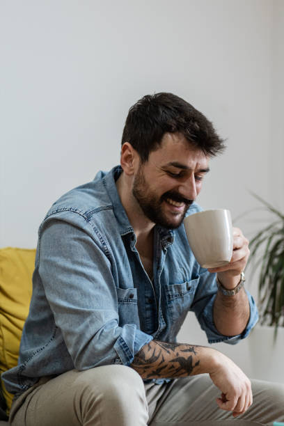 istock Handsome young man drinking his morning cup of coffee 1384936762