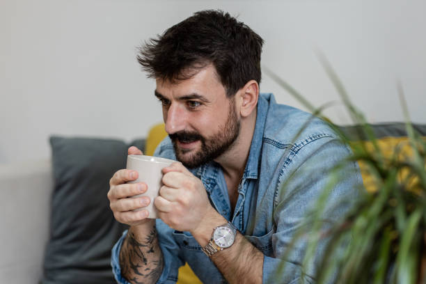 istock Handsome young man drinking his morning cup of coffee 1384943668