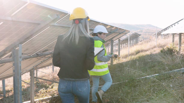 istock Female engineers working in solar power plant. Teamwork. Renewable energy systems. Solar city. 1384946910
