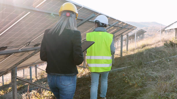 istock Female engineers working in solar power plant. Teamwork. Renewable energy systems. Solar city. 1384946916