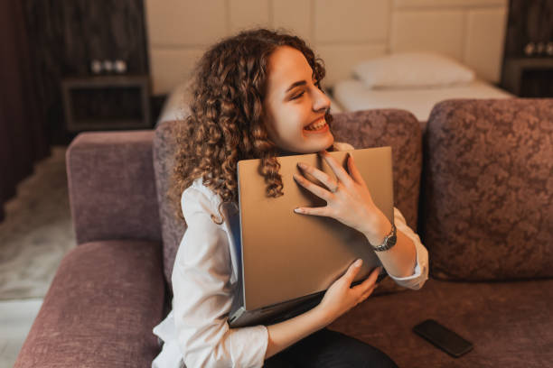 istock E-commerce. Student work on laptop. Redhead curly girl working at home at computer. Crazy person enjoy good work. Victory in business project. Joyful emotions. Celebrate victory.  Business achievement 1384947720