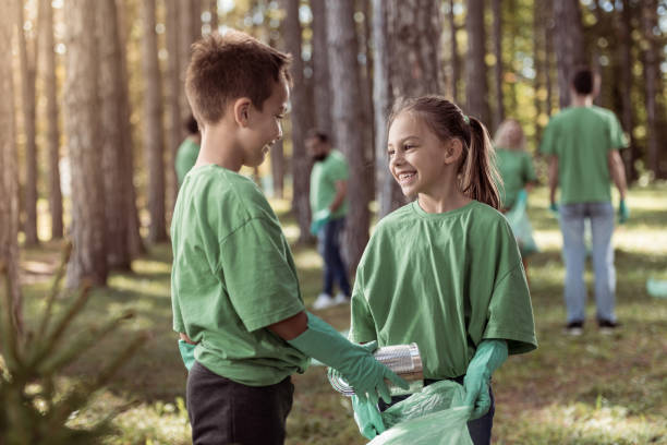 istock Kids cleaning up the forest 1384952458