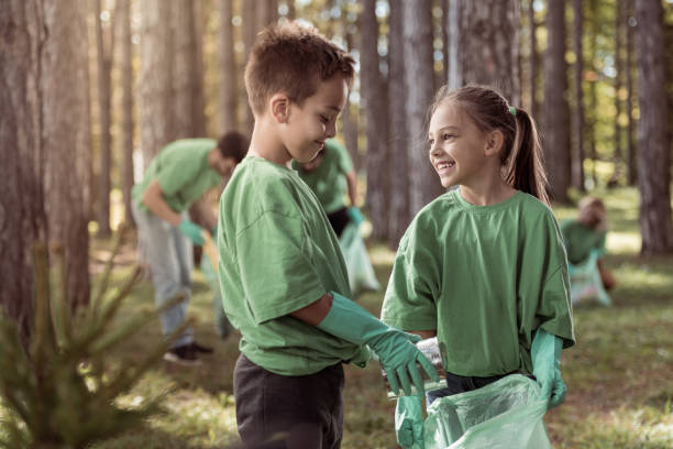 istock Kids cleaning up the forest 1384962372