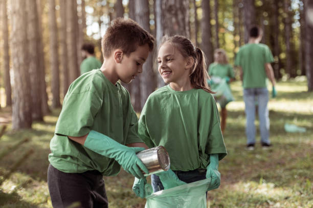 istock Kids cleaning up the forest 1384962467