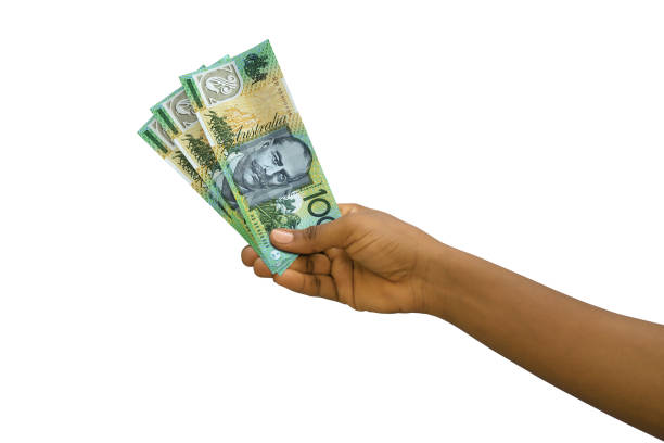 istock Fair hand holding 3D rendered Australian dollar notes isolated on white background 1384978302