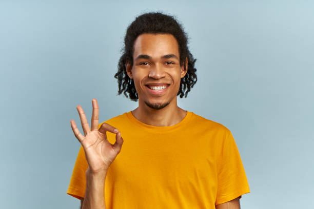 istock African man looking at camera, satisfied client with smile showing ok gesture 1384979382