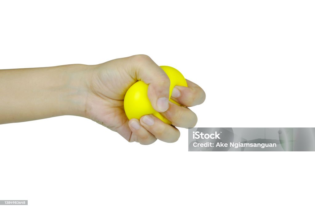 Hands of man with a gentle personality He exhibits stressful behavior from work, and he squeezes the yellow ball expressing emotion, anger, displeasure. Medical concepts and emotional regulation Adult Stock Photo