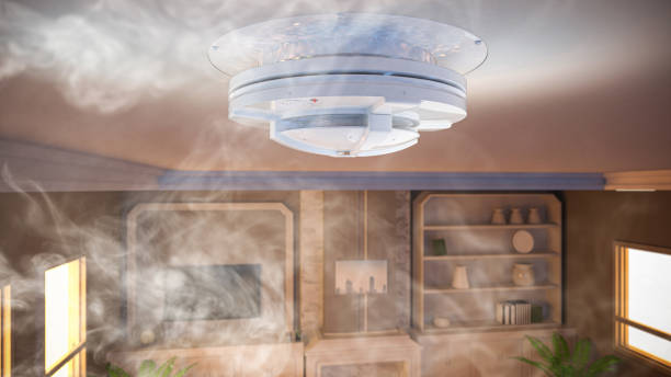 Smoke detector on ceiling in house stock photo
