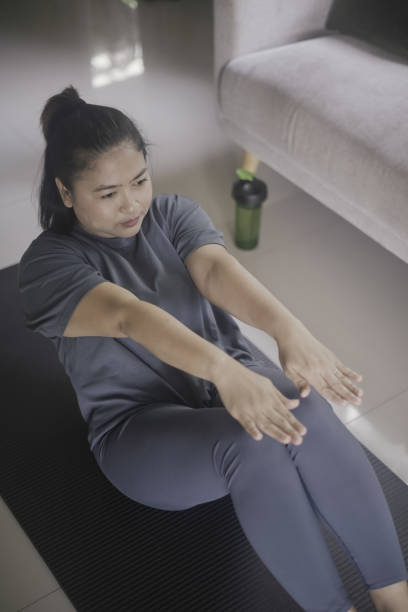 istock Woman exercising indoors at home 1384985687