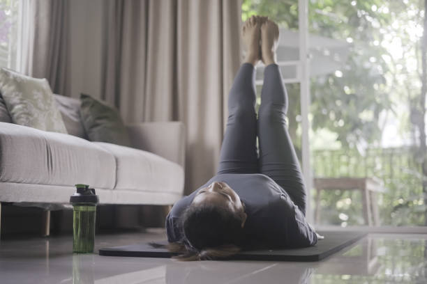 istock Woman exercising indoors at home 1384985692