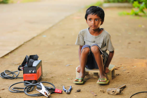 istock stop child labor : indian child working at factory 1384987225