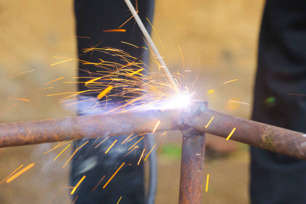 istock Welders working and jointing iron pipe at the factory 1384987227