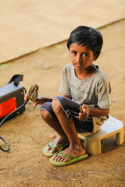 stop child labor : indian child working at factory