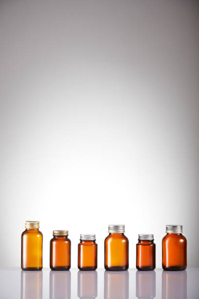 istock Set of empty brown glass medicine bottles. Amber bottle samples. 1384997952